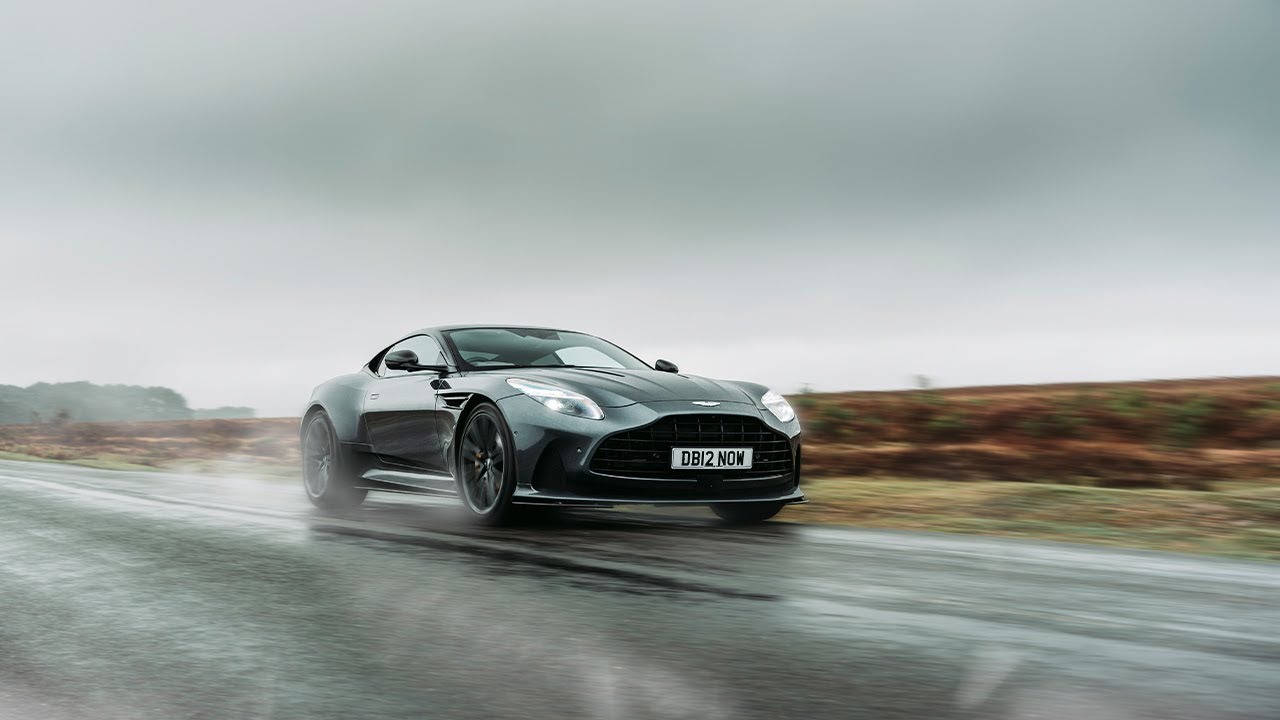 Aston Martin DB12 on a wet road under low cloud
